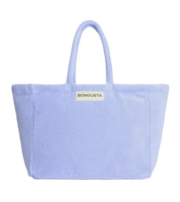 Bolso weekend de Bongusta en tejido toalla color lavanda: amplio, cómodo y perfecto para llevar lo imprescindible en escapadas de fin de semana o días de playa.